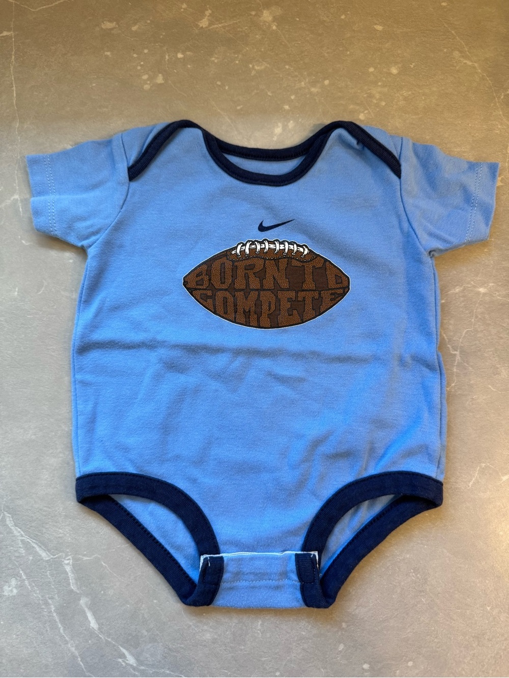 Nike Light Blue Baby Bodysuit with Navy Trim and Football Graphic